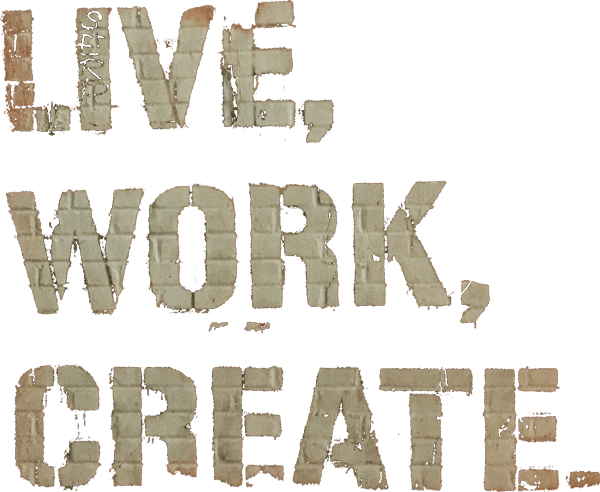 Live, Work, Create. The words Live, Work, Create in block letters painted on a brick wall